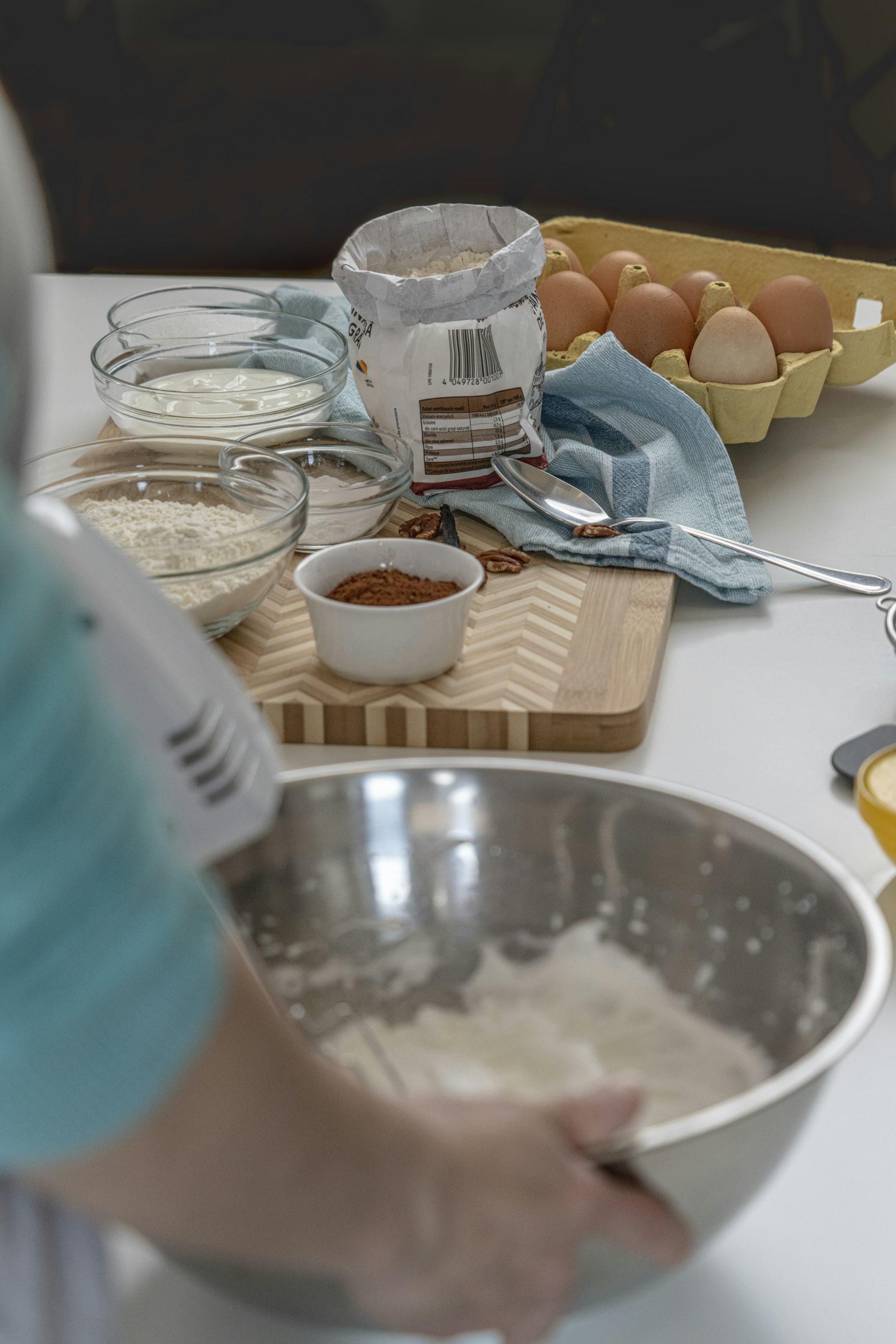 A smartphone sitting on a kitchen counter next to fresh ingredients and a cutting board