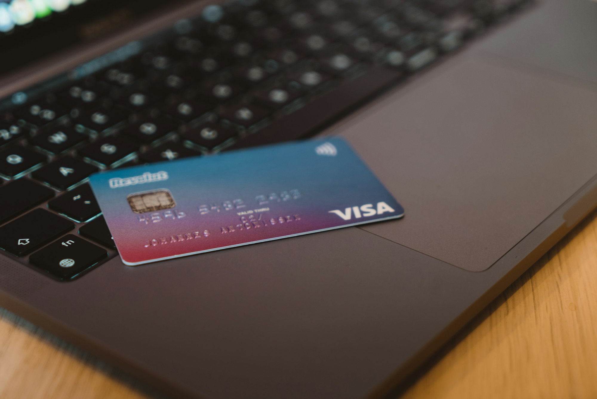A credit card resting on a laptop keyboard