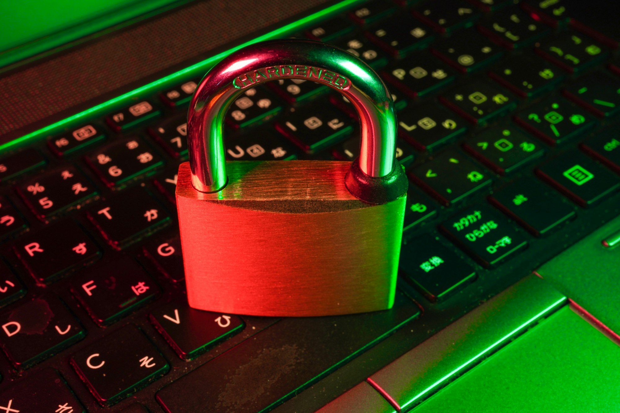 A red padlock resting on a laptop keyboard