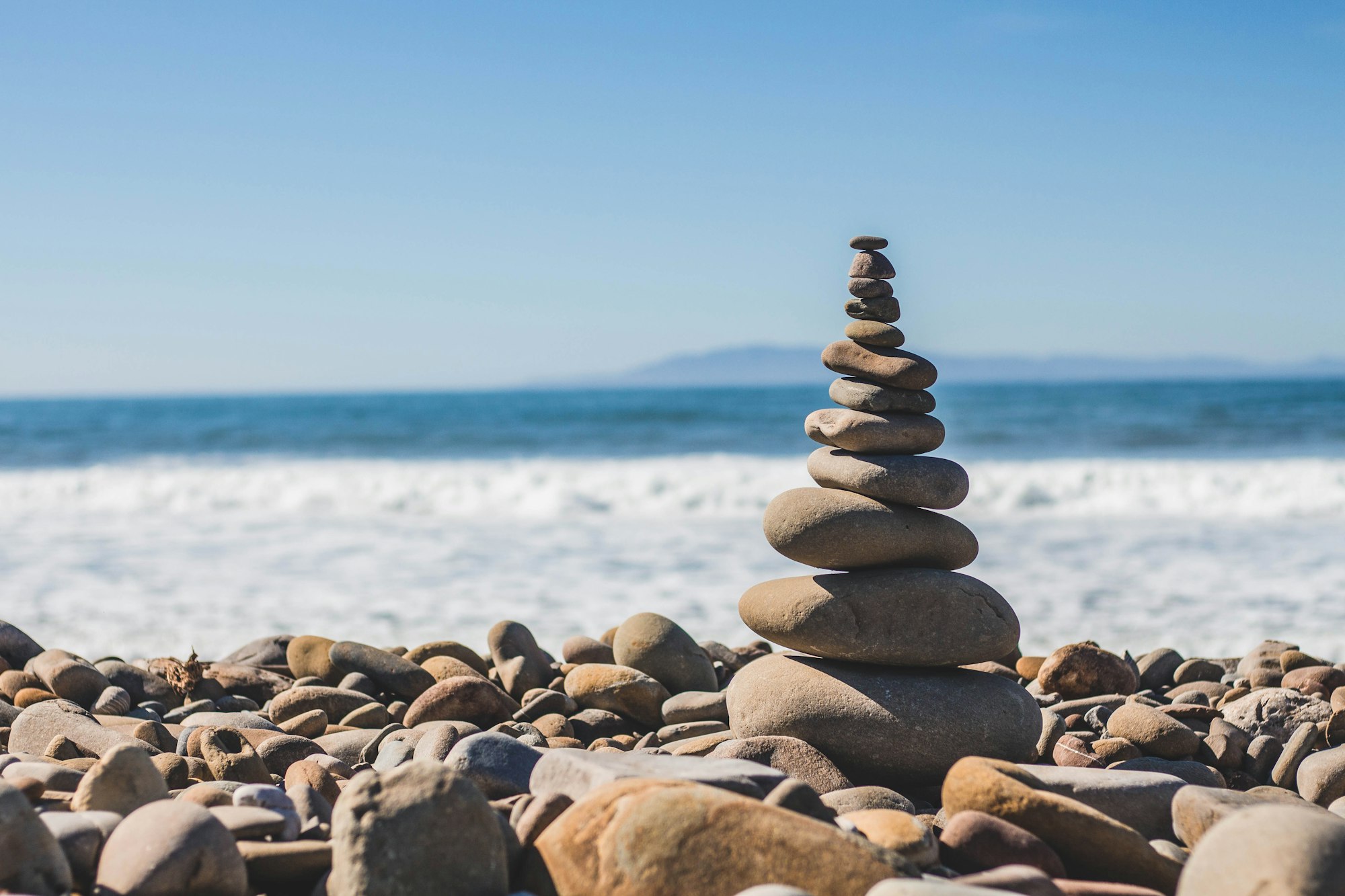 A balanced stack of rocks on the seashore