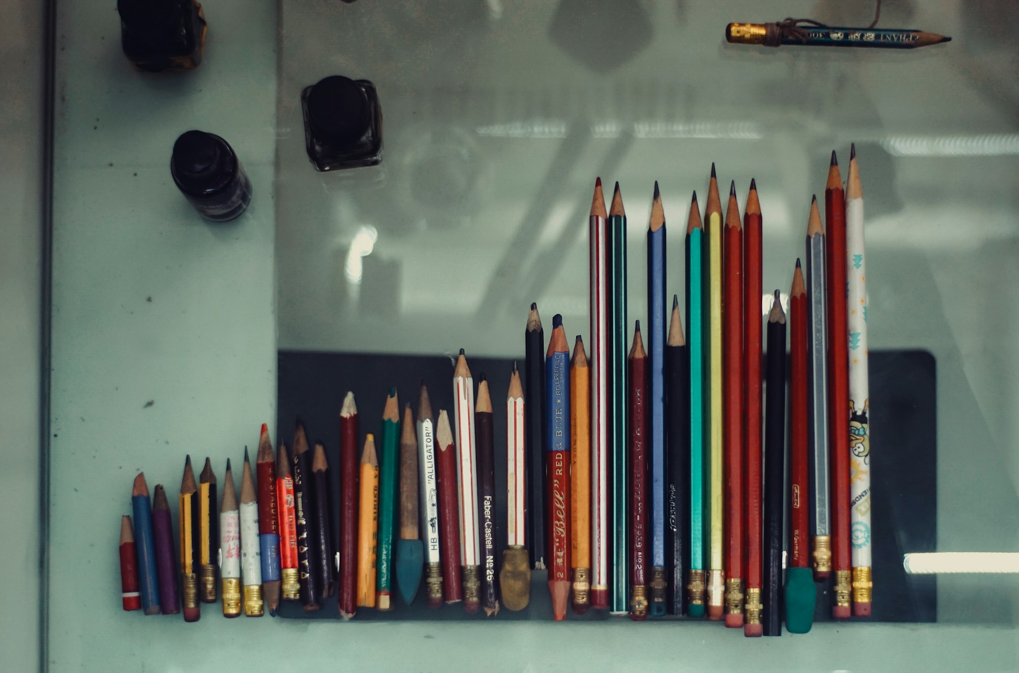 A collection of colored pencils and art tools