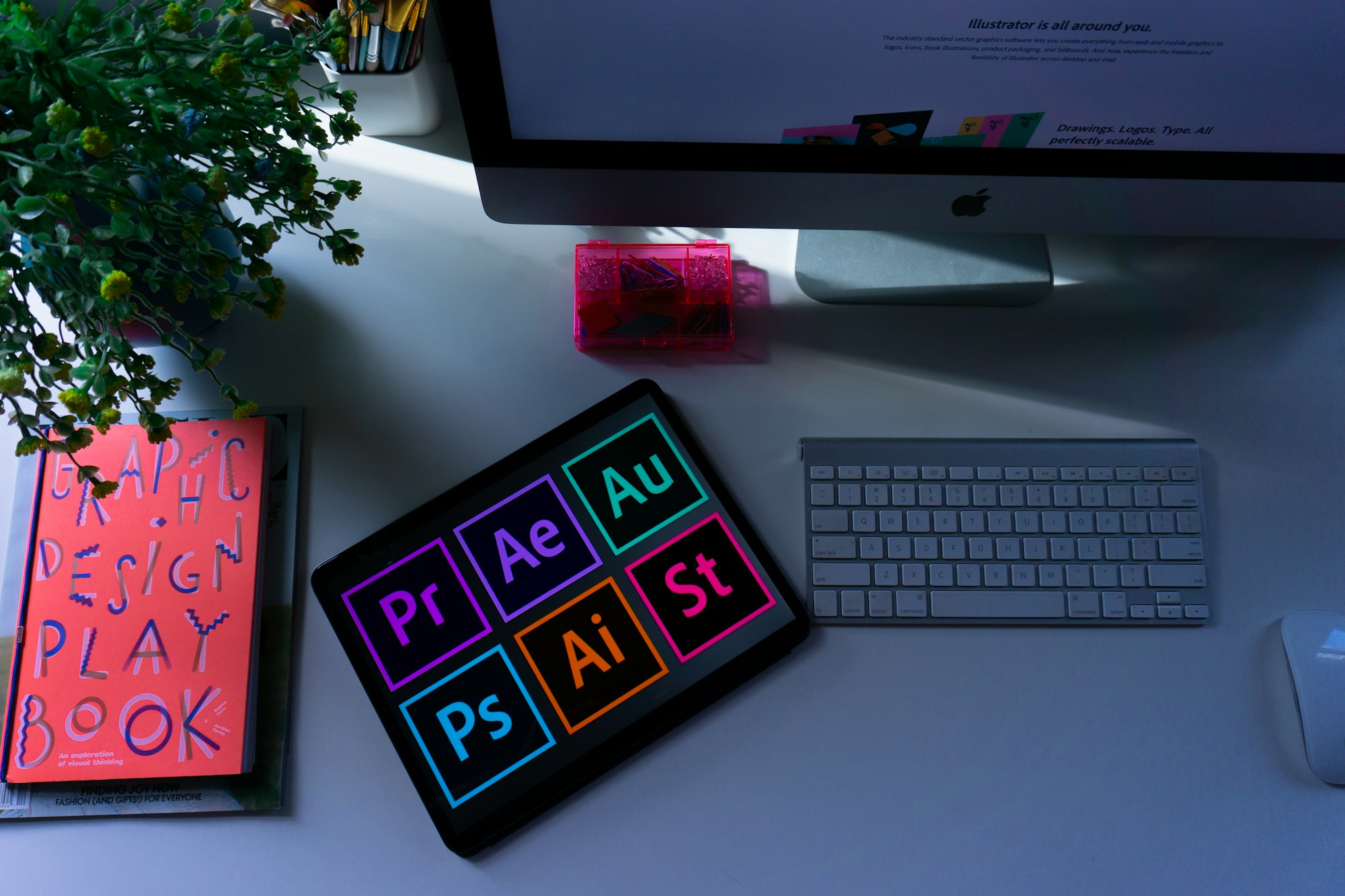 A designer's desk with an iMac and keyboard