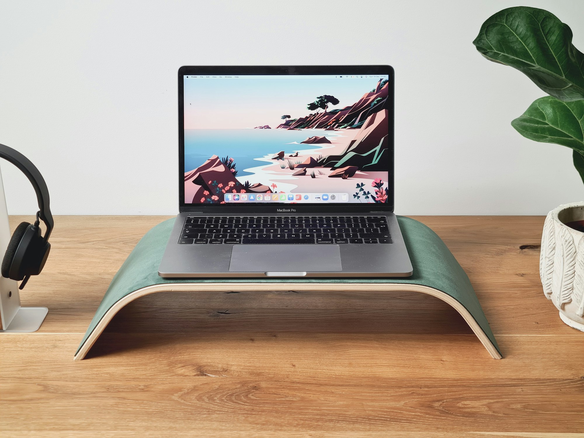 A clean desk setup with monitor and laptop