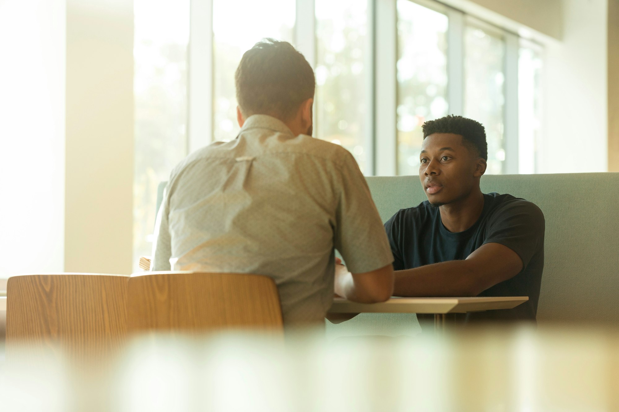Two men talking in an office setting