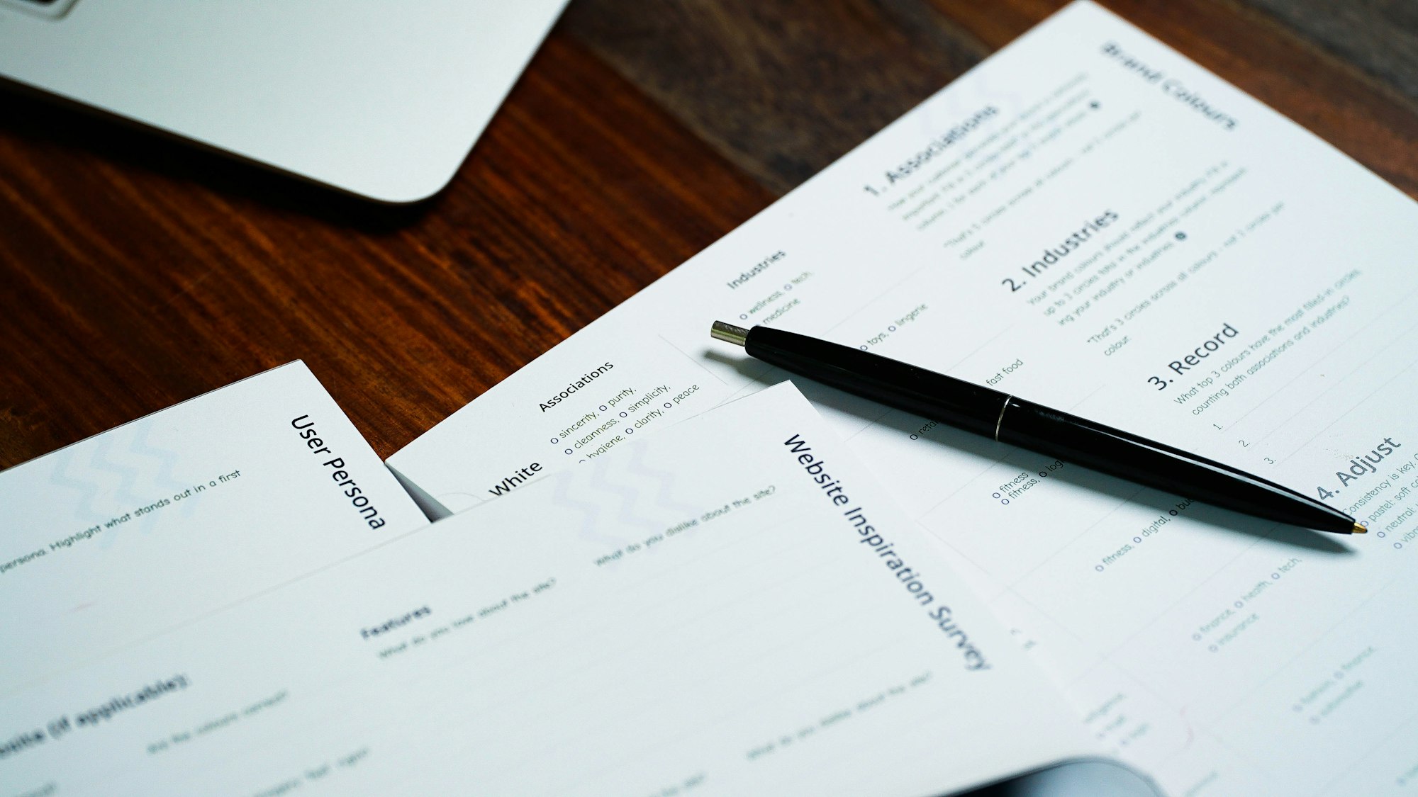 A pen resting on a pile of paperwork