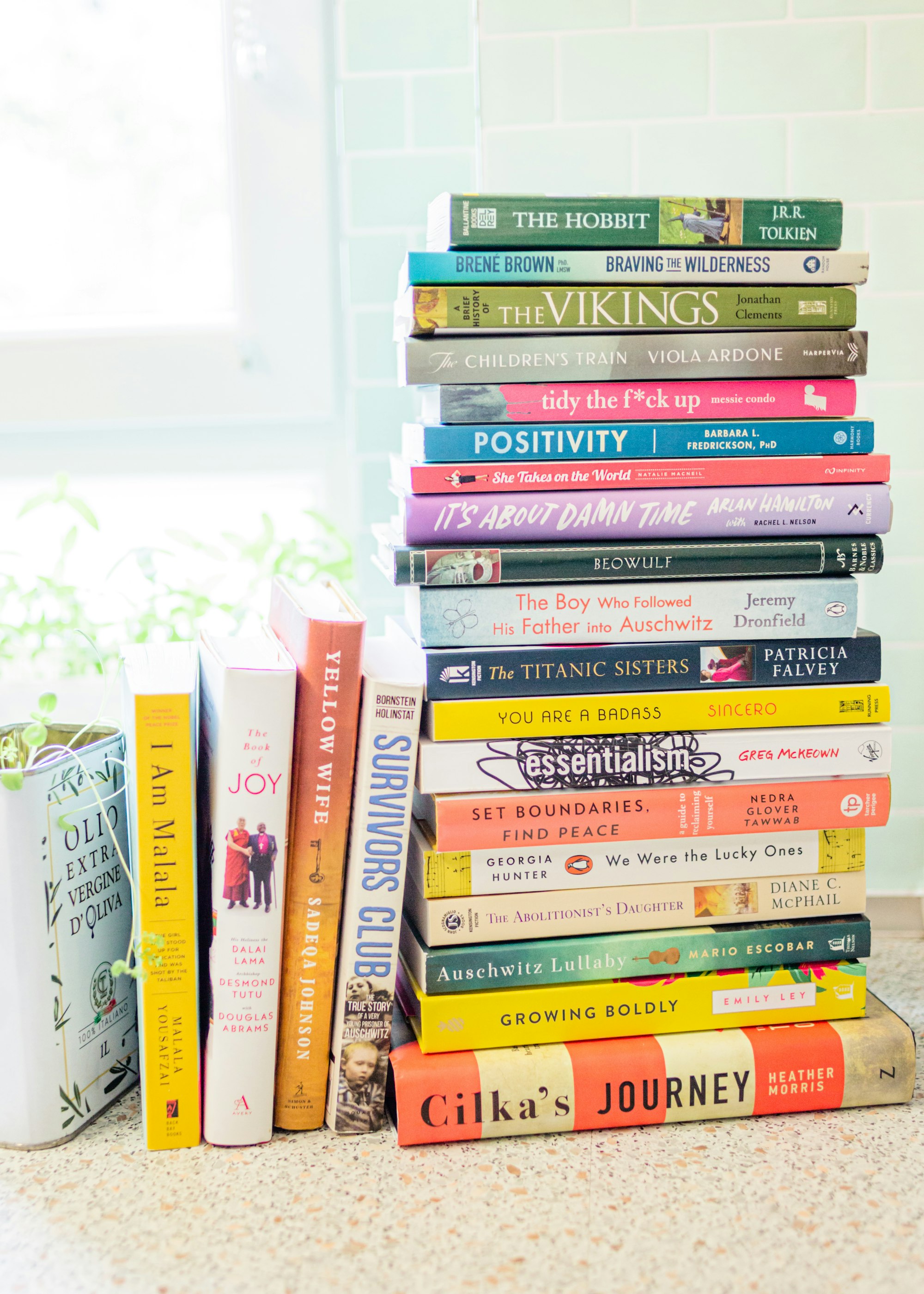 Stack of books on a desk with a cup of coffee