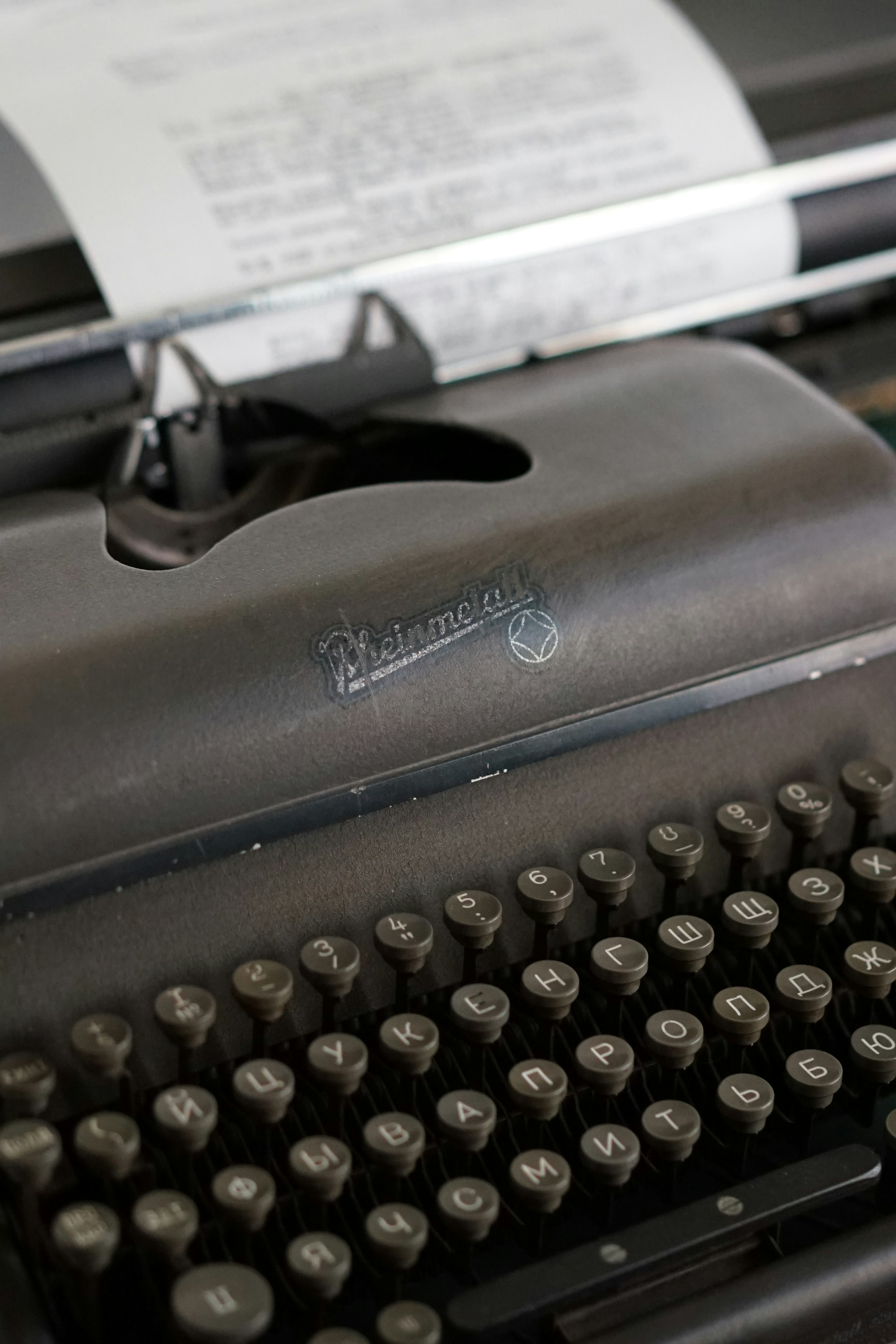 Vintage black typewriter with a sheet of paper