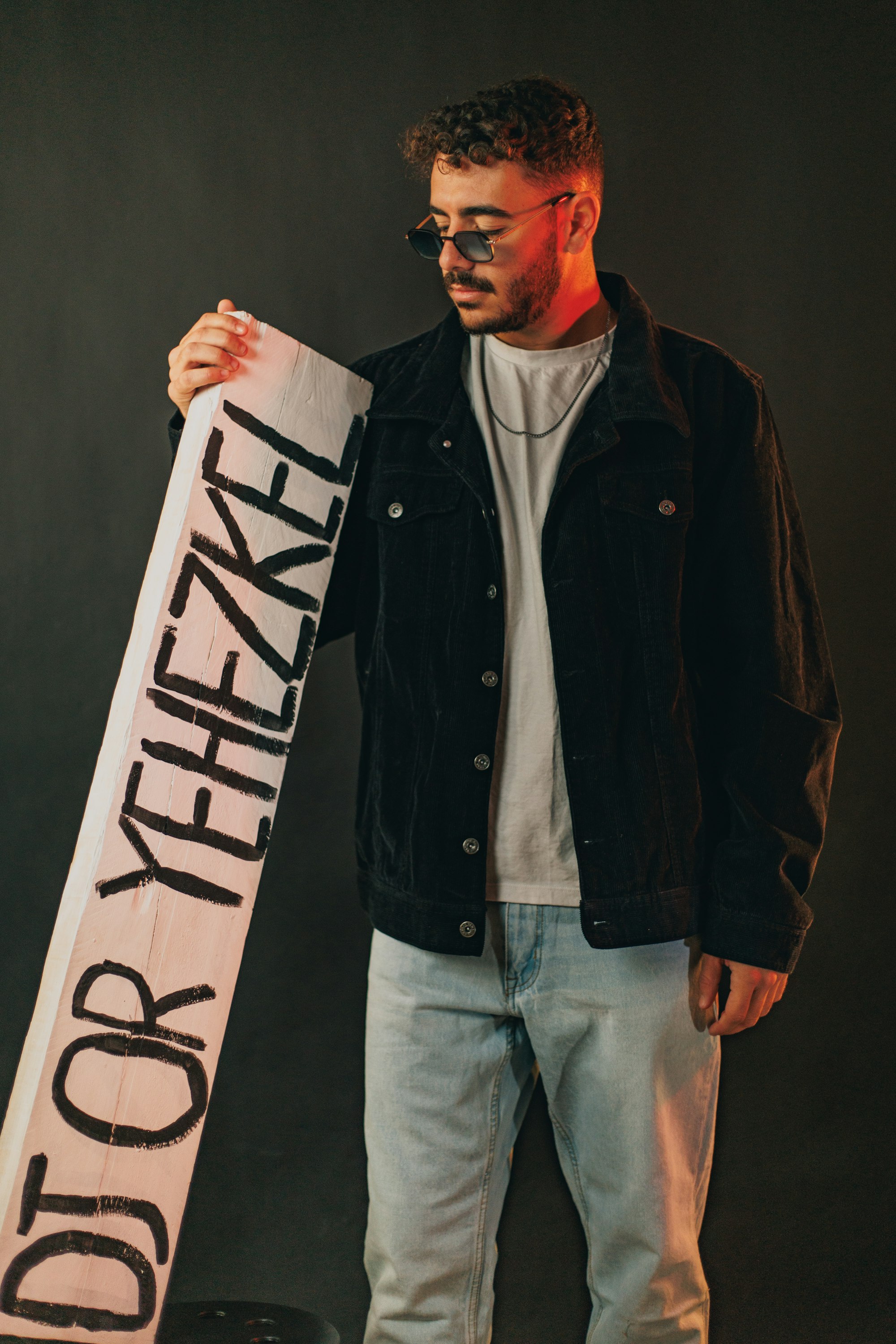 Man holding a sign with text on it