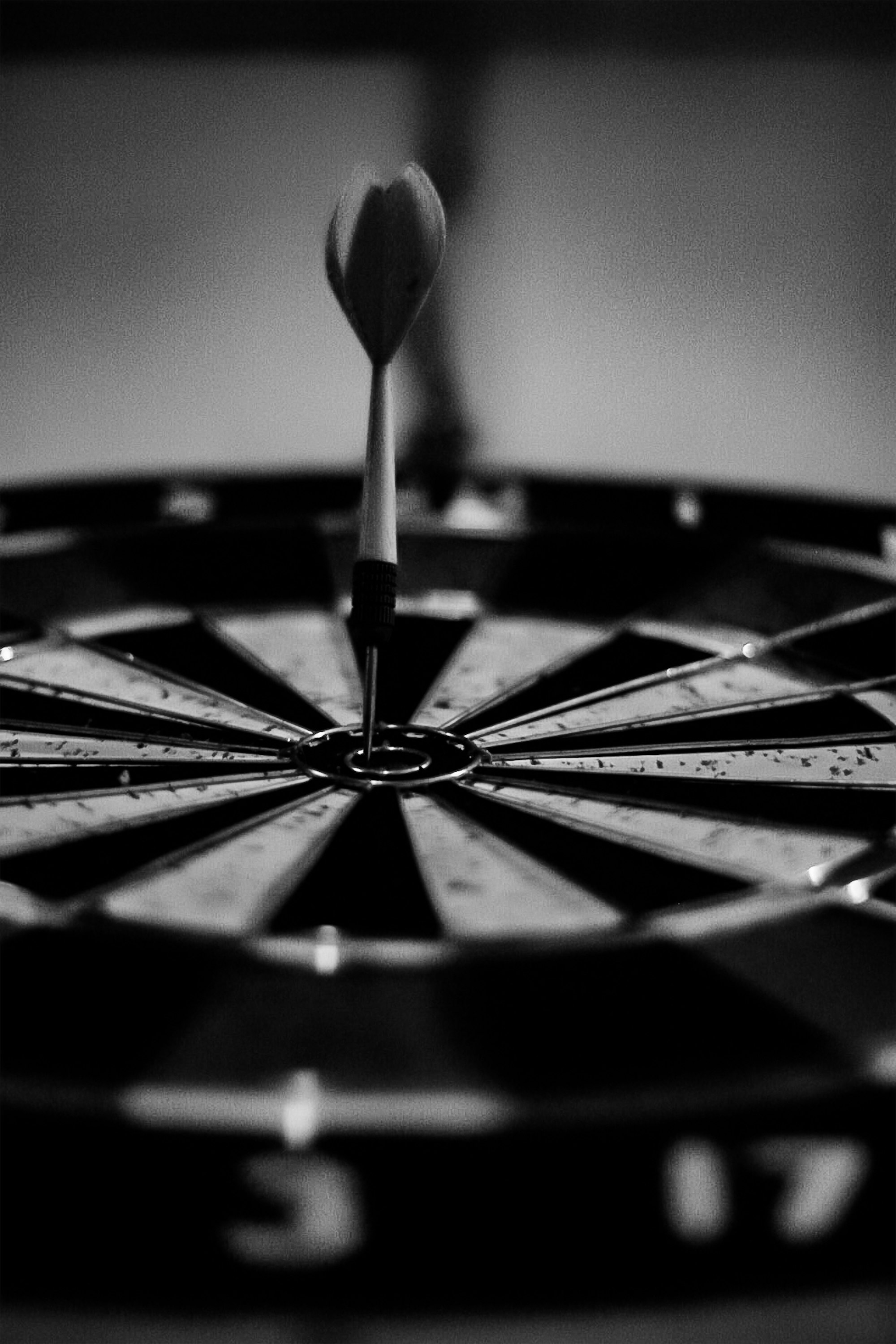 Dart stuck in the bullseye of a dartboard