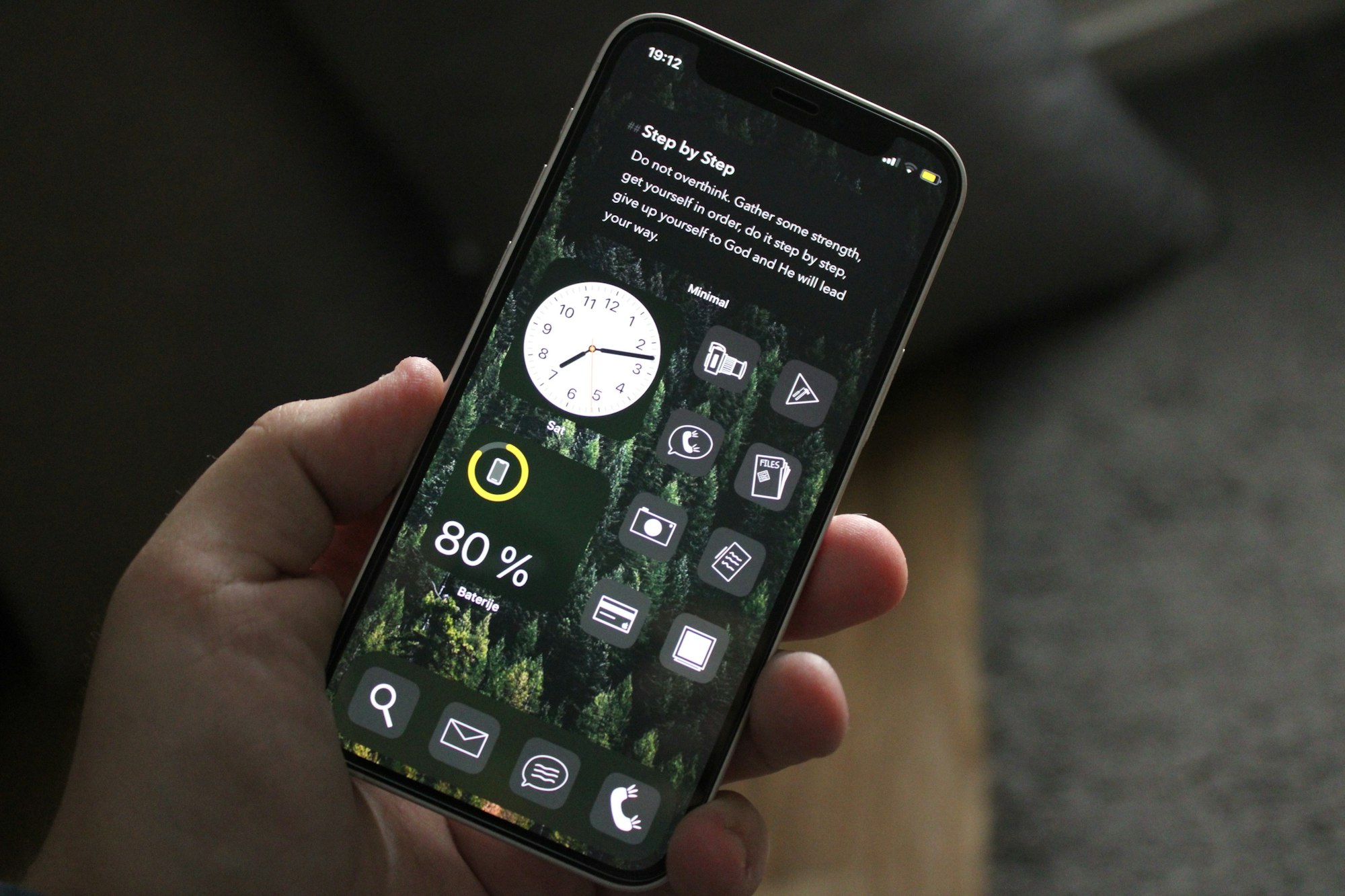 A person holding a cell phone in their hand