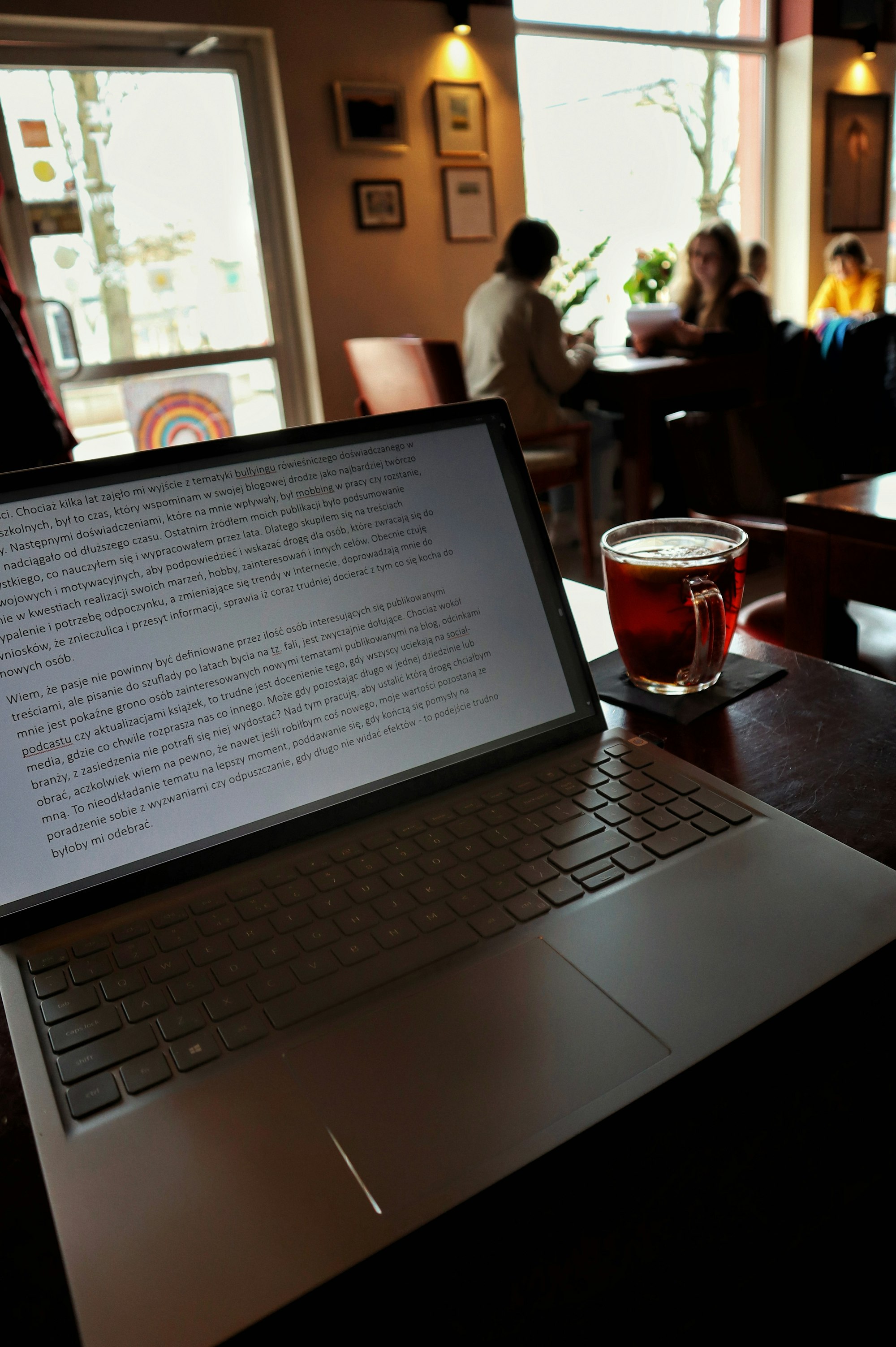 Laptop with a drink in a coffee shop