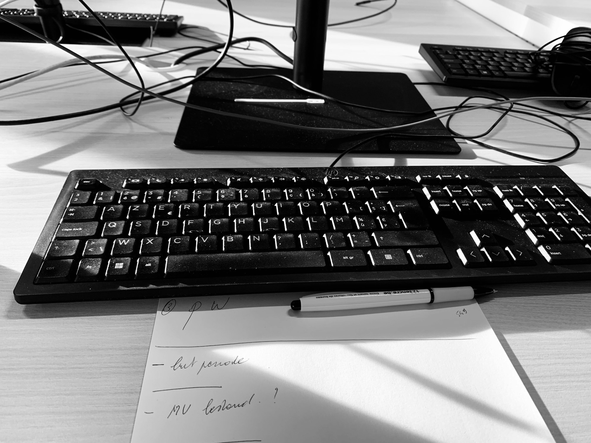Keyboard and paper with pen on desk