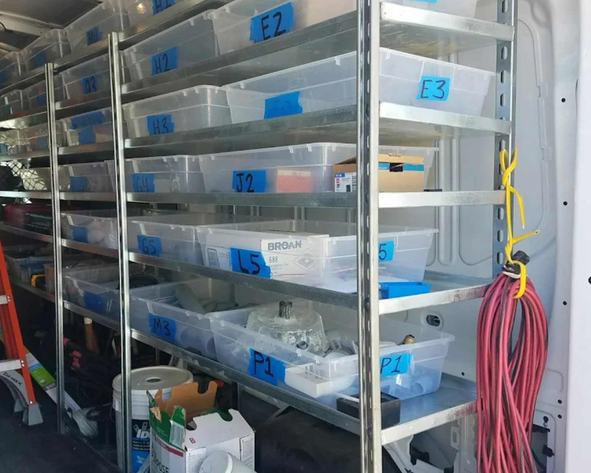 Shelves filled with labeled plastic bins and supplies