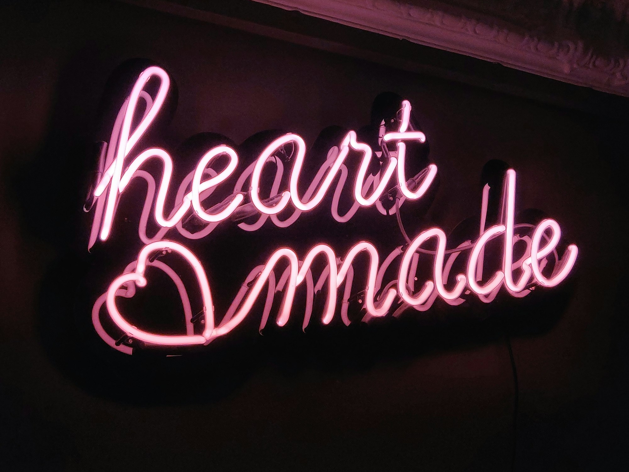 Purple and white UNKs neon light signage