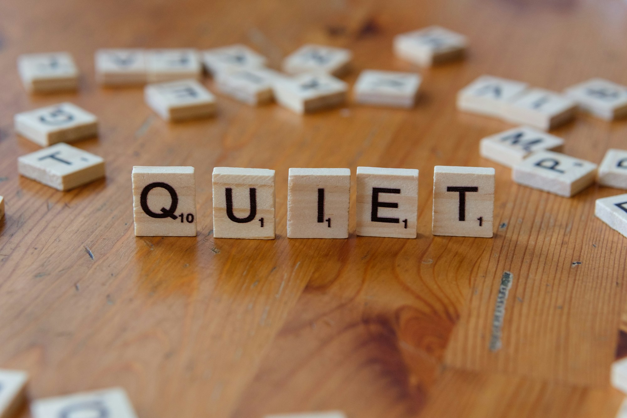 The word quiet spelled with wooden blocks on a table