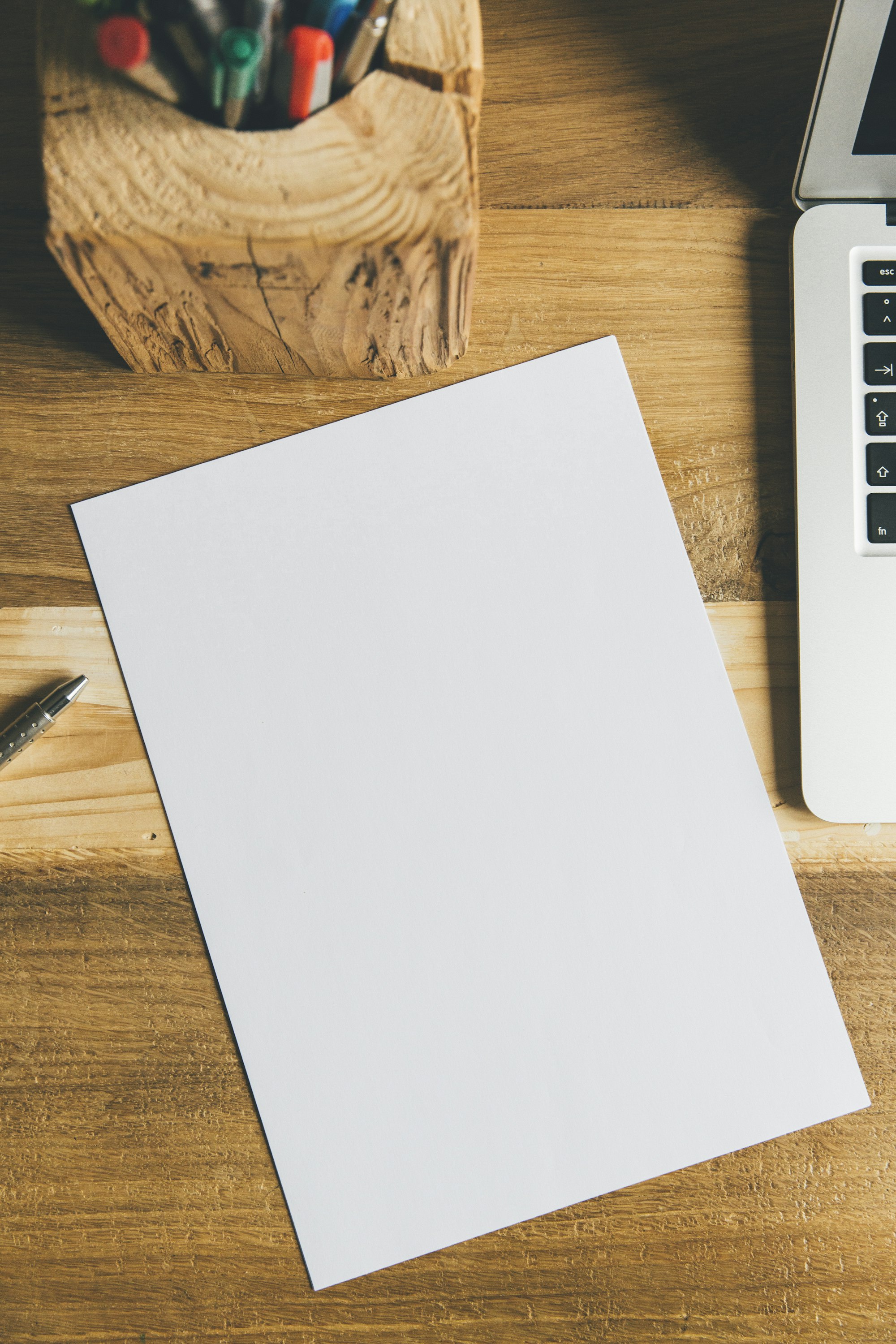 White printer paper beside black pen