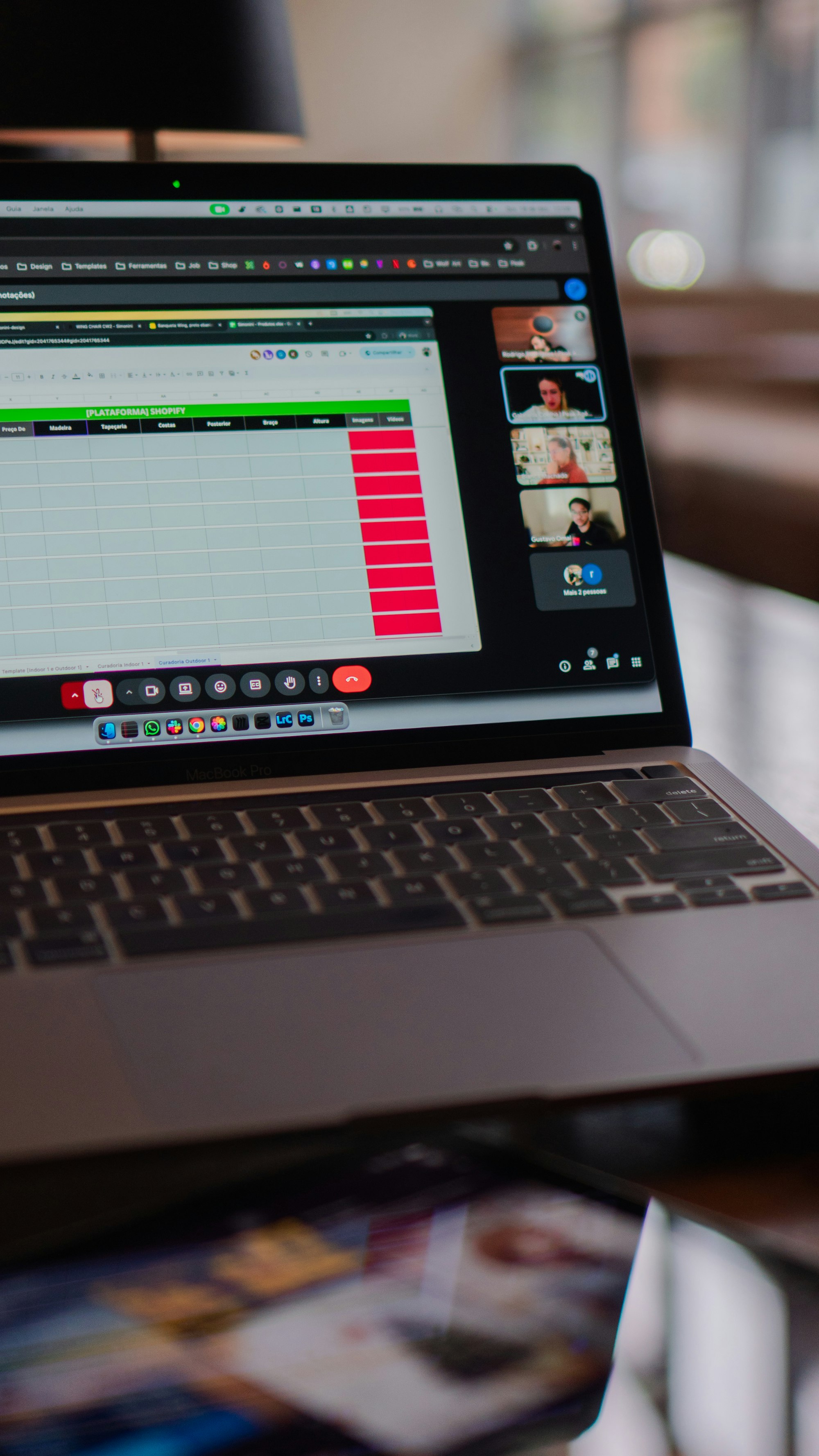 Laptop screen showing a video conference and spreadsheet