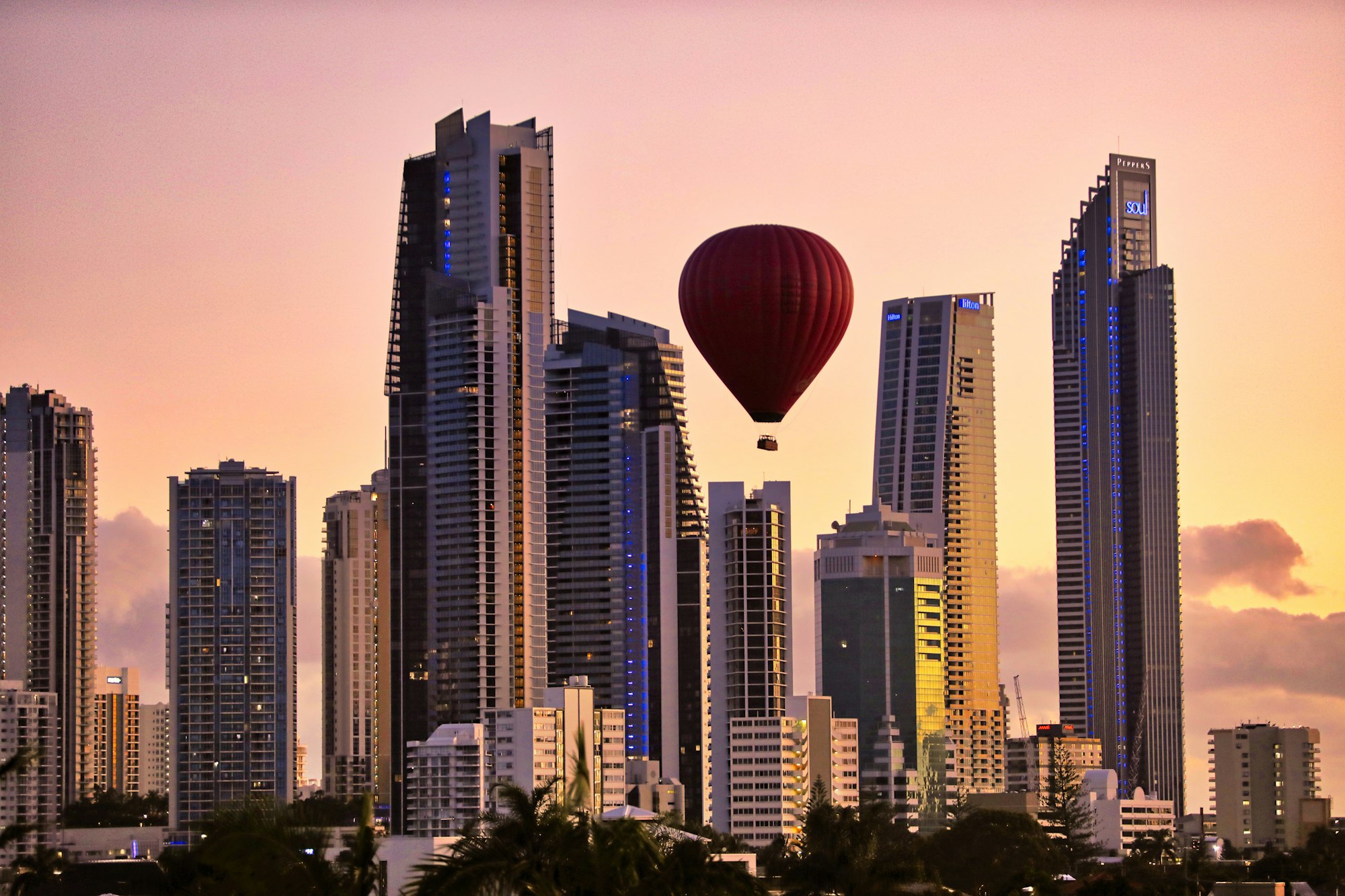 A hot air balloon in the sky over a city