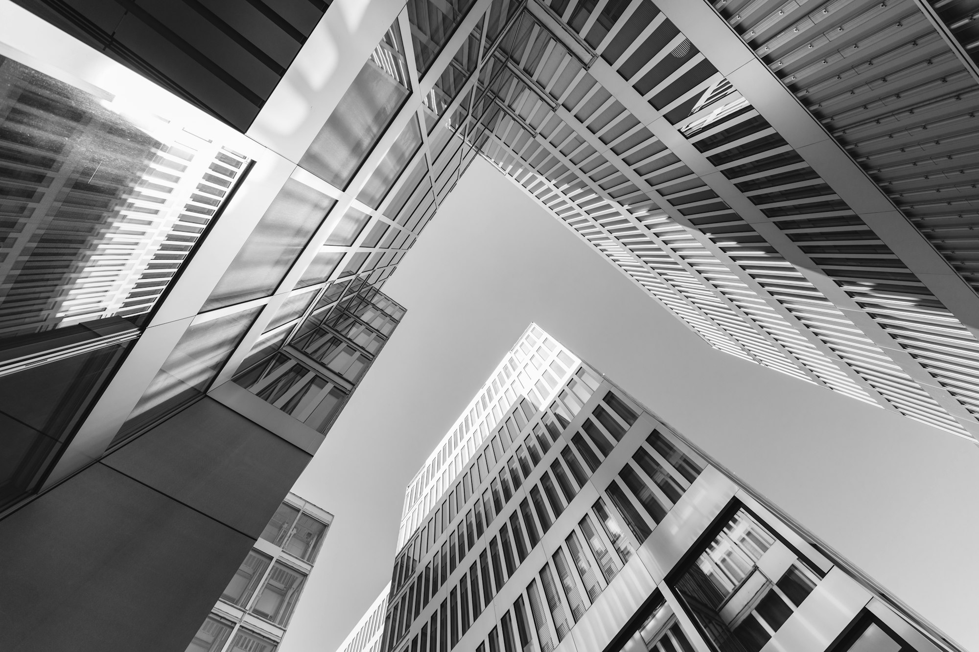 A grayscale photo of a modern high-rise building