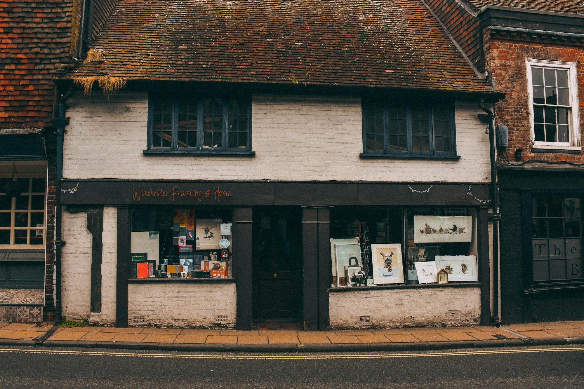 A white brick building with a store front