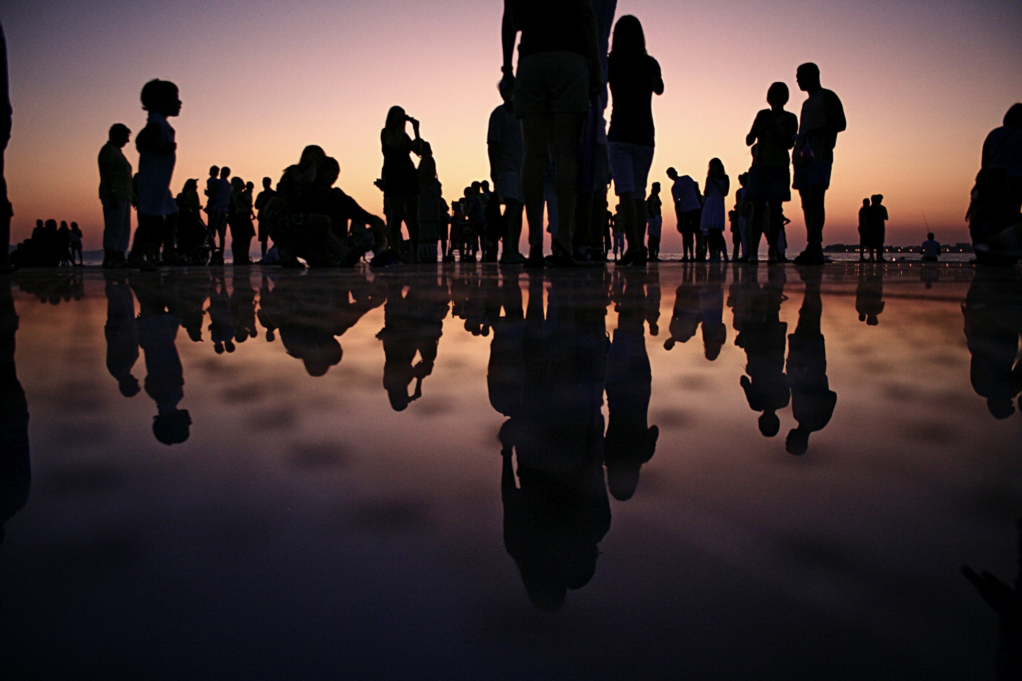 Silhouettes of a group of people at golden hour