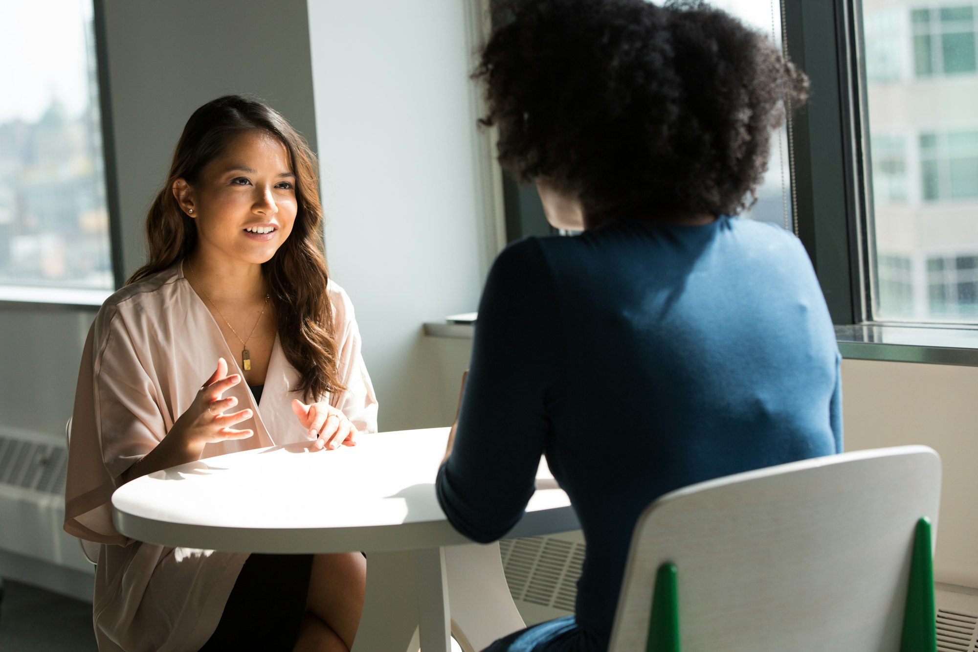Two people sitting across from each other in discussion