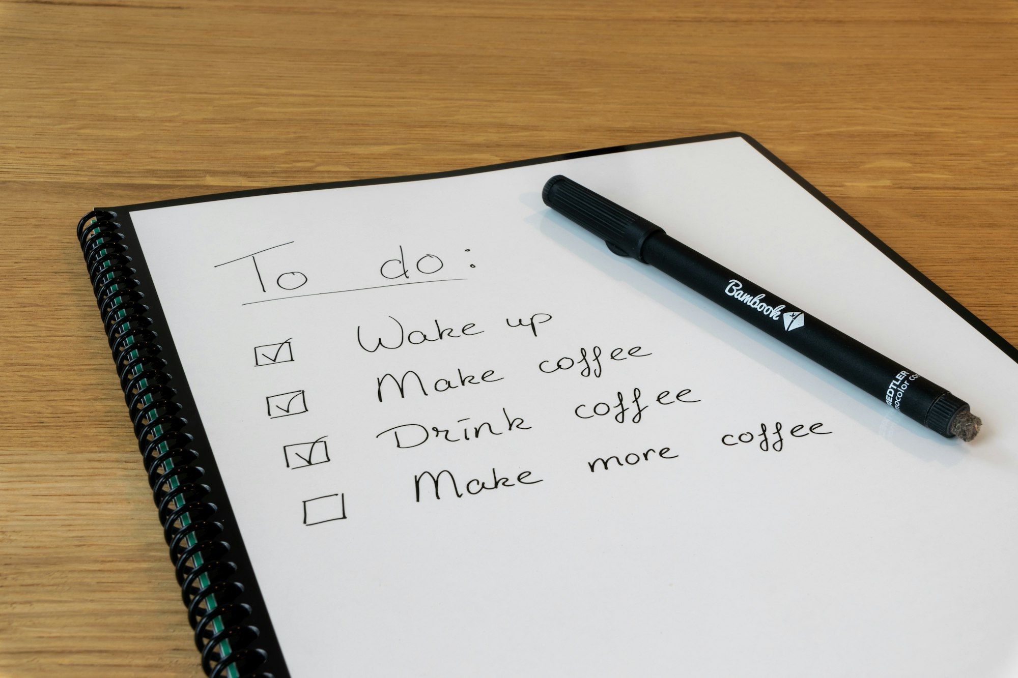 A to-do list notepad with a pen on top
