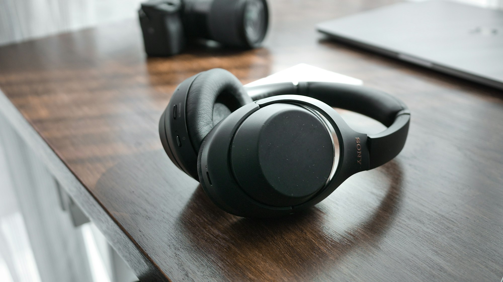 A pair of headphones on a wooden study desk