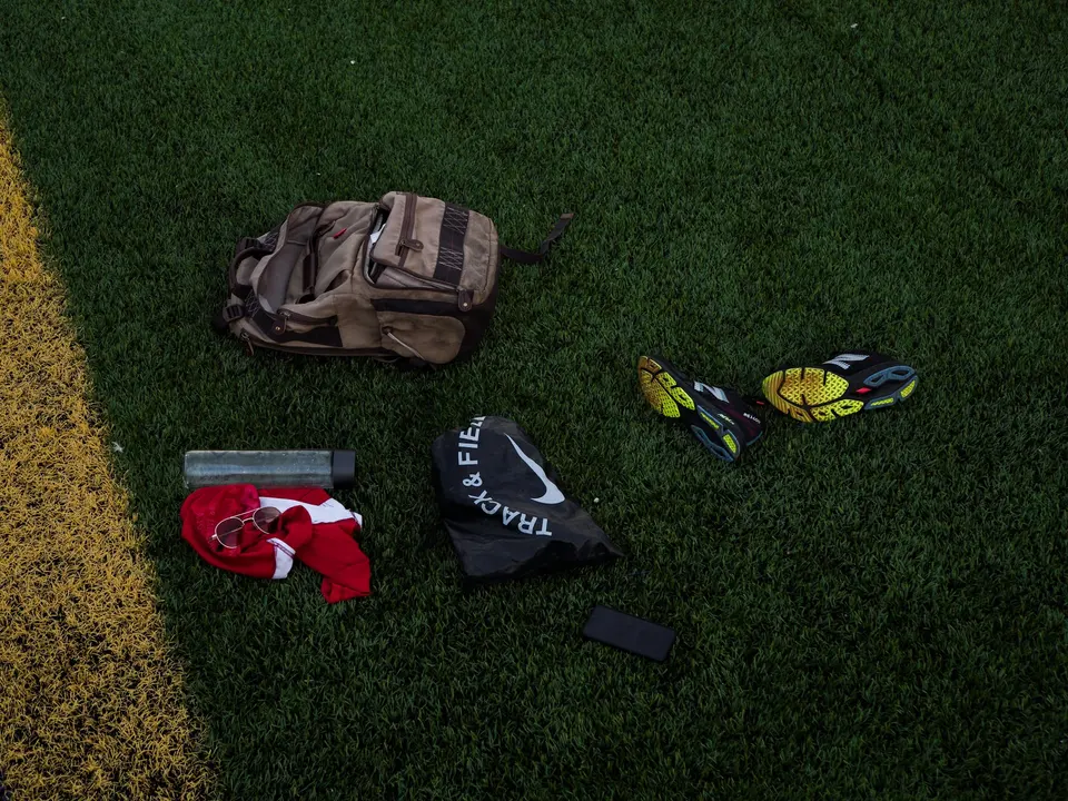 Backpack, shoes, and clothing laid out on grass
