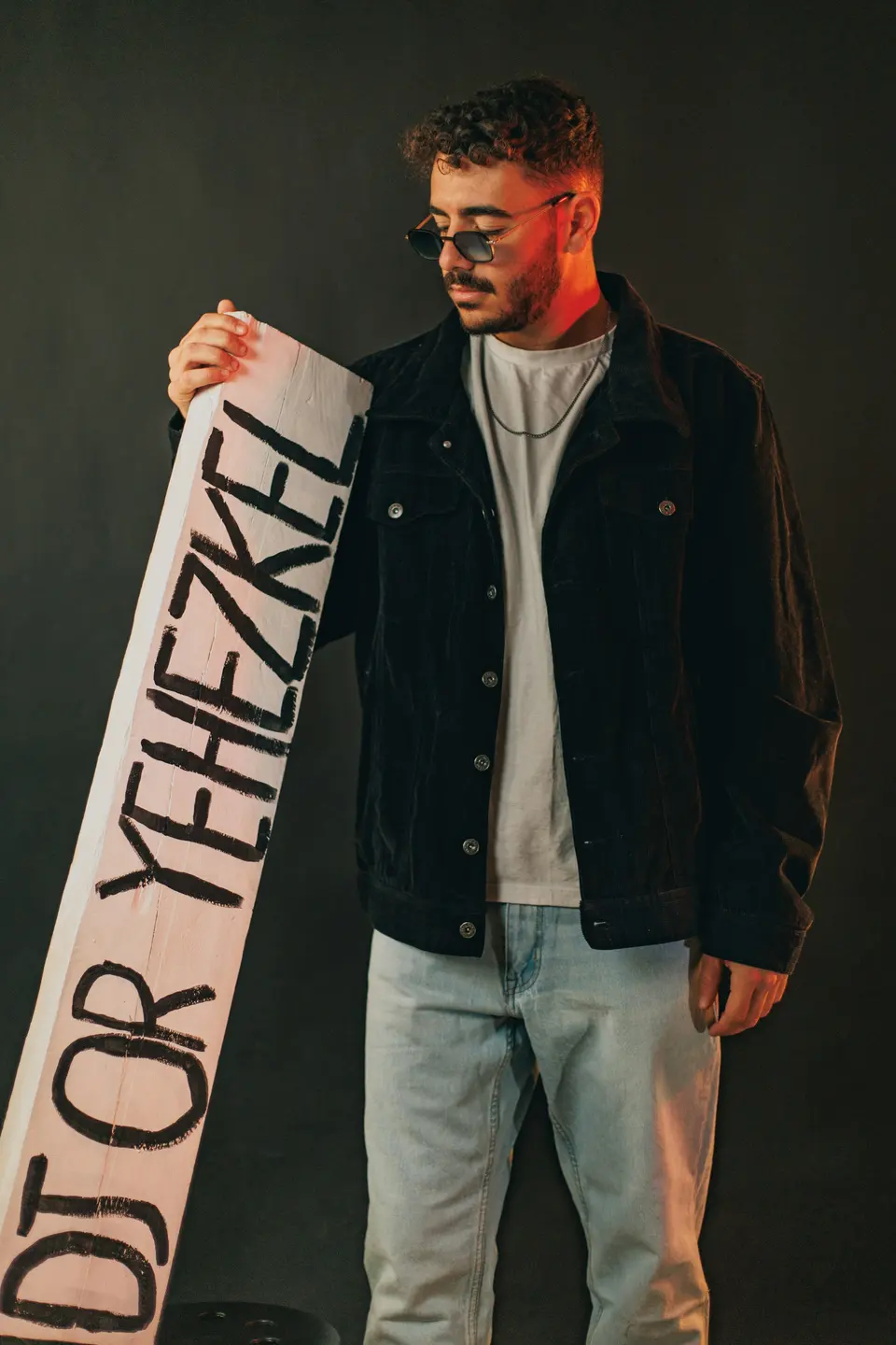 Man holding a sign with text on it