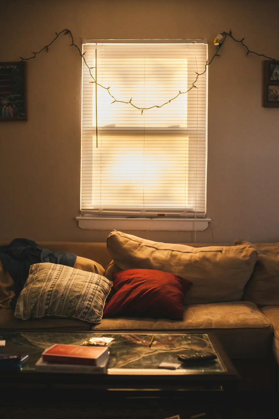 Red throw pillow on brown couch