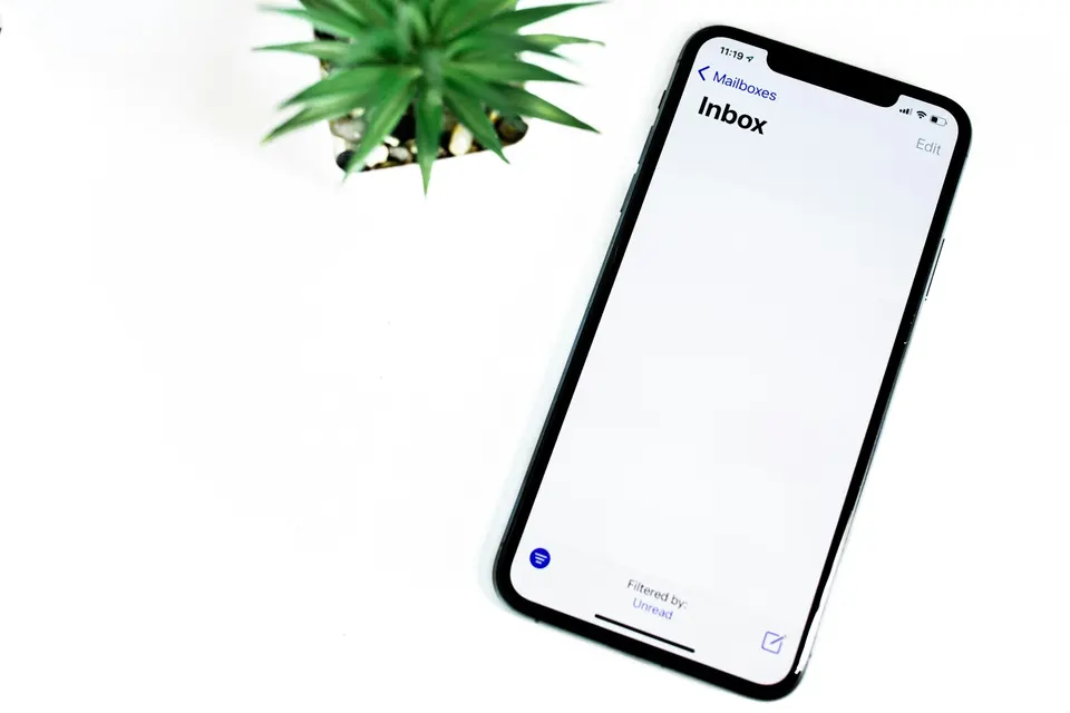 Black iphone 5 on white surface