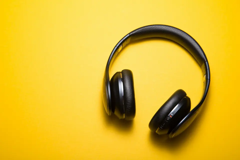 Headphones resting on a wooden desk with soft studio lighting