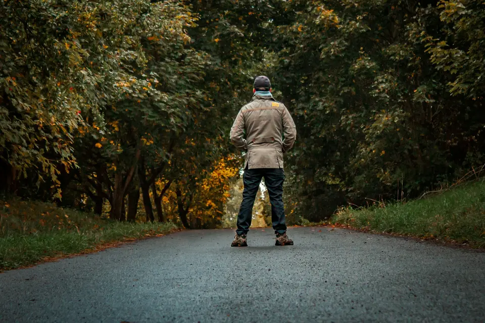 A person riding a skateboard down a road