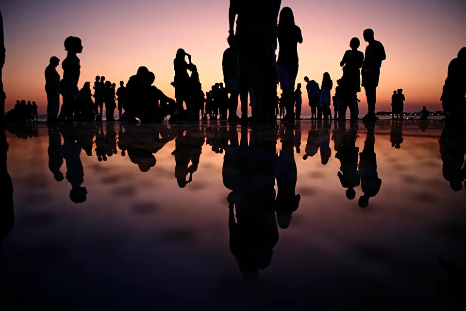 Silhouettes of a group of people at golden hour